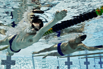 Men swimming in swimming pool