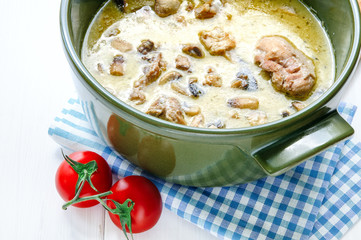 Fricassee of chicken with mushrooms in ceramic pot