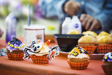 Various decorated muffins at table during Halloween party