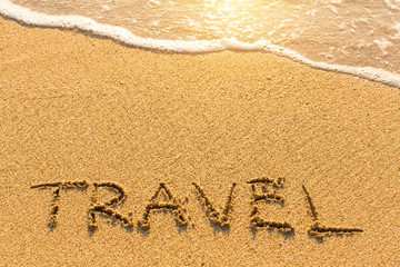 Travel - inscription on sand beach with the soft wave.