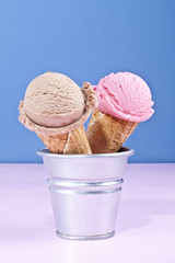 Chocolate and strawberry ice cream cones.