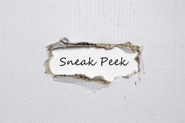The word sneak peek appearing behind torn paper. - 113213200