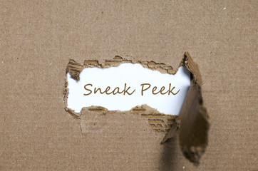 The word sneak peek appearing behind torn paper. - 113213216