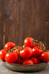 Fresh red tomatoes, isolated on dark background