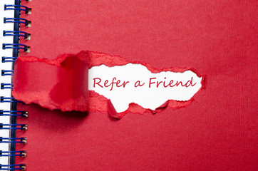 The word refer a friend appearing behind torn paper.