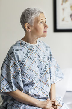 Thoughtful female patient sitting in hospital