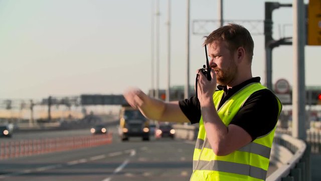 Traffic police with walkie talkie work at highway
