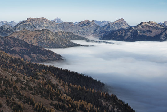 View of fog and mountains against sky 