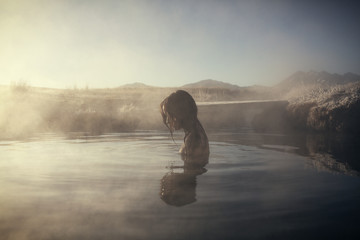 Woman bathing in hot spring