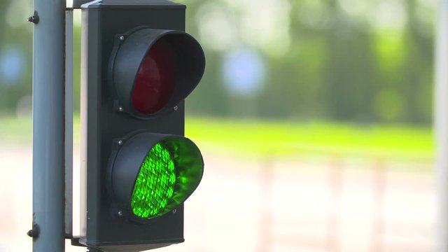 Automatic Road Barrier Gate Lifting gate opens and passes car in the background of traffic light