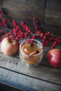 Close up of cider with an apple slice and cinnamon stick