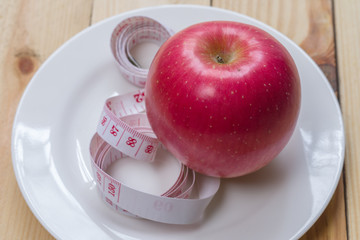 Delicious red apples and measured the meter on wooden background,Healthy food,Diet concept