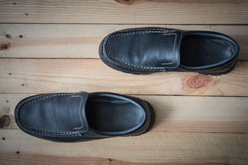 Closeup of back men's boots on wooden background