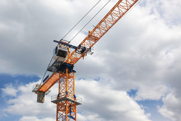 Orange Crane In Front Of Sky and Clouds