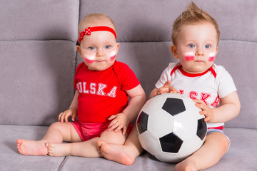 Soccer baby twins fans of Poland team in national colors