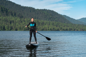 Happy woman on paddle board