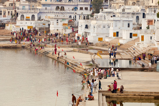 People at Pushkar lake against town