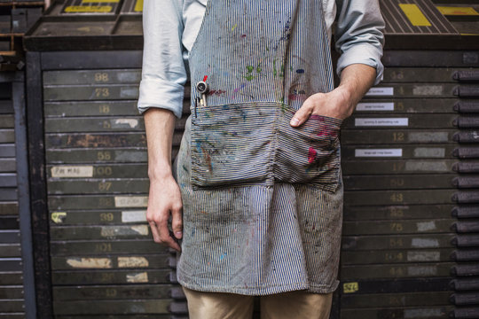 Midsection of worker with dirty apron