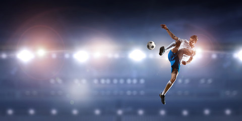 Fototapeta na wymiar Soccer player hitting ball