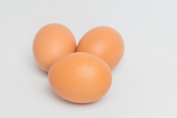 three eggs on white background,three eggs on fabric background, closeup three eggs