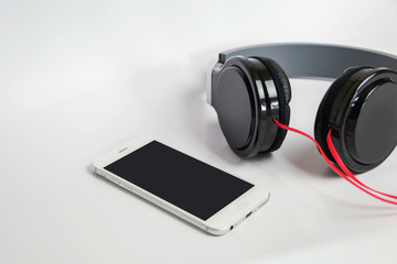 music concept - smartphone and headphones on the wood background,smartphone and headphones close-up