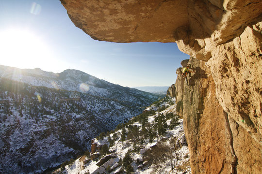 Man climbing rock ledge