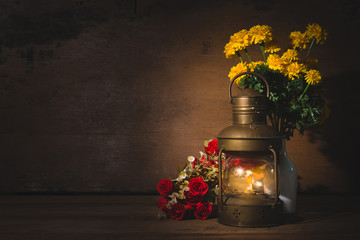 Vintage kerosene lamp on wooden table over grunge background. still life