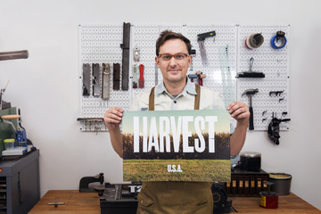 Craftsperson holding picture with text