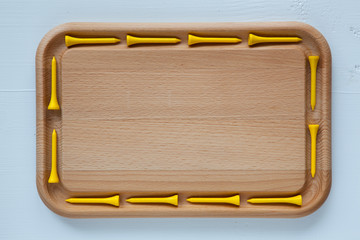 Empty cutting board with different golf tees