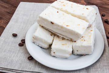 cup of cappuccino with cinnamon and white cakes