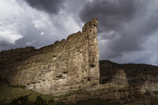 View of rock formation against stormy cloud