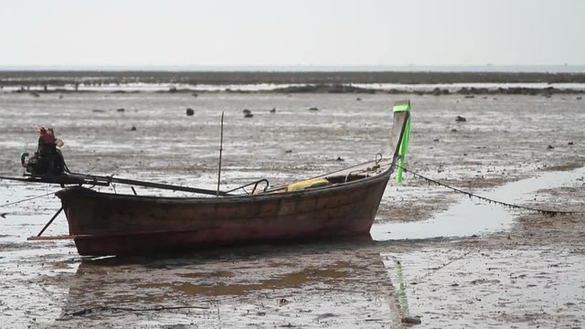 Wooden boat on the beach at low tide
