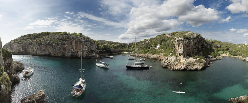 Bay of water with yachts among rocks