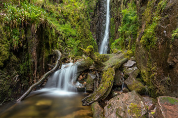 Beautiful remote flowing waterfall Scale Force with cascade in the English Lake District.