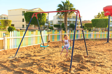 little girl on a swing