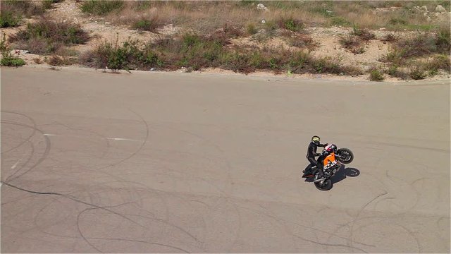 Motorcycle stuntman - Aerial top shot.