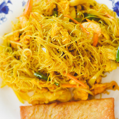Top view closeup on noodles cooking with shrimps, table background