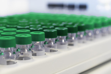 Rows of glass vials in the tray automatic liquid dispenser.