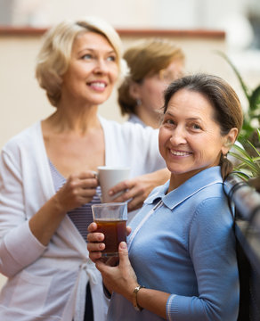 Three women drinking tea at balcony