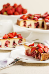 Homemade strawberry cake on a white cake stand.