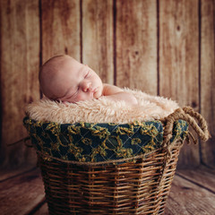 Cute Sleeping Newborn Baby In A Wooden Basket