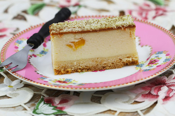 Slice of baked cheesecake with peach, closeup
