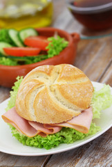 Lunch consisting of chicken sandwich and green salad
