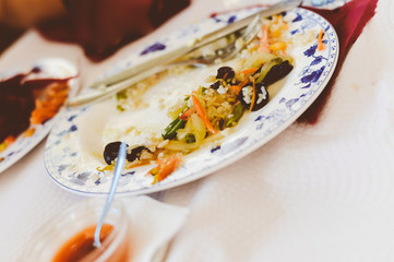 Pan fried shrimps sauce and egg rice in white dish closeup table background
