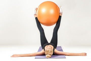 Young woman training with fitball