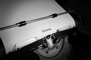 Old typewriter and inserted sheet of paper with medical report on bulimia