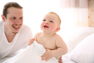 Young father is having fun with his little baby