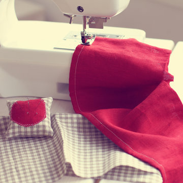 sewing fabric in home hobby/ background with sewing fabric on the sewing machine 