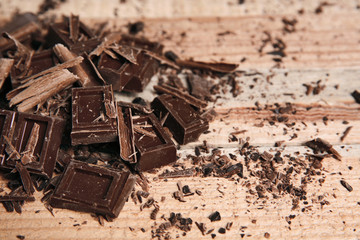 Chocolate pieces on wooden background