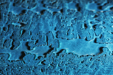 Water drops on blue glass background